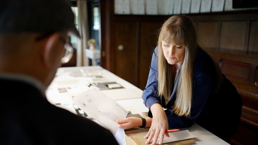 Homeowner reviewing how to budget for a home renovation, with plans and material samples.